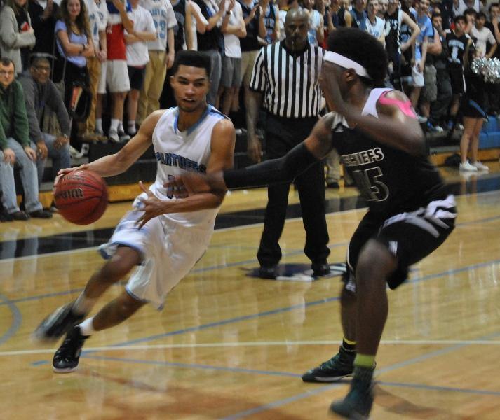 Senior guard Cedric Simmons drives to the basket against a McIntosh defender in the second meeting of the year between the Chiefs and Panthers.