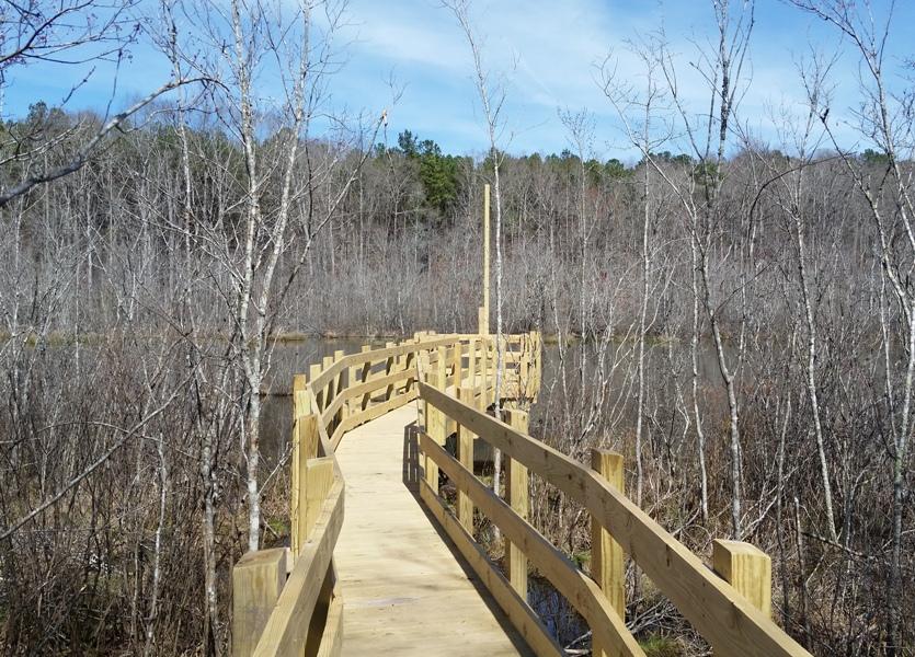 The bridge dead-ends at Beaver Pond behind the high school. 