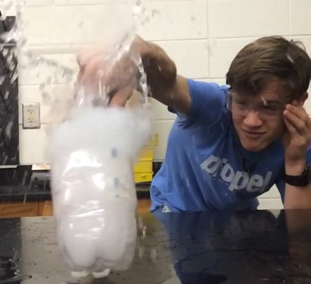 Sophomore Kade Smith performs the dry ice lab in Craig Martins gifted chemistry class. 