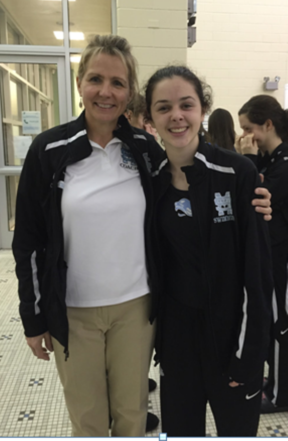 Swimming coach Robin Huggins gives freshman Reilly Adams a hug during the Fayette County championship meet, which the Panthers won for the 15th year in a row. Adams improved greatly over the season and placed 12th in the 100 freestyle at the meet.