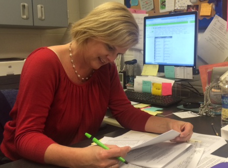 Guidance Counselor Paula OShields examines the recognition list from the Georgia Department of Education. 