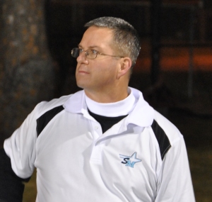 Scott King looks over the marching band as they load their equipment into the marching band trailer after one of their competitions. 