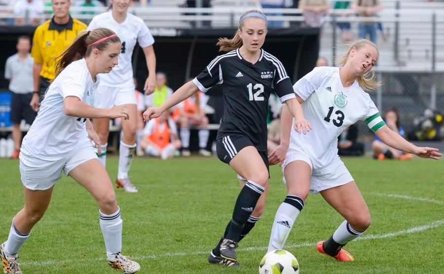 Sophomore midfielder Ashley Broderick weaves through two McIntosh defenders.