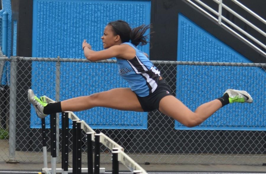 Junior Alexis Farley competes in the hurdles events during the county championship on March 14.