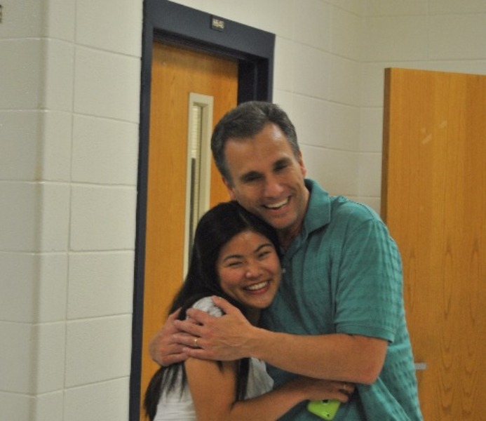 Science teacher Craig Martin heart-warmingly hugs one of his former students Daele Paraman.  