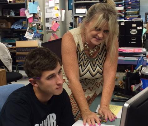 Technology teacher Pat Coleman aids senior Charlie Gable with his Computer Applications project. Coleman is excited that the Fayette County high schools will soon offer digital animation courses. 