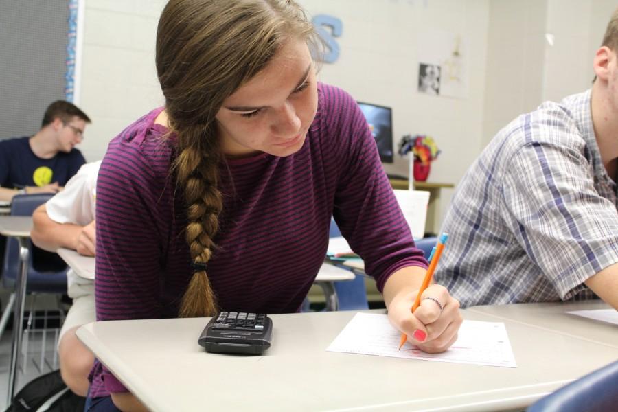 Aug. 20, 2015- A junior works on her math homework in Emily Woodward’s Advanced Algebra class. She gives students time at the end of class to start on their homework and ask questions.