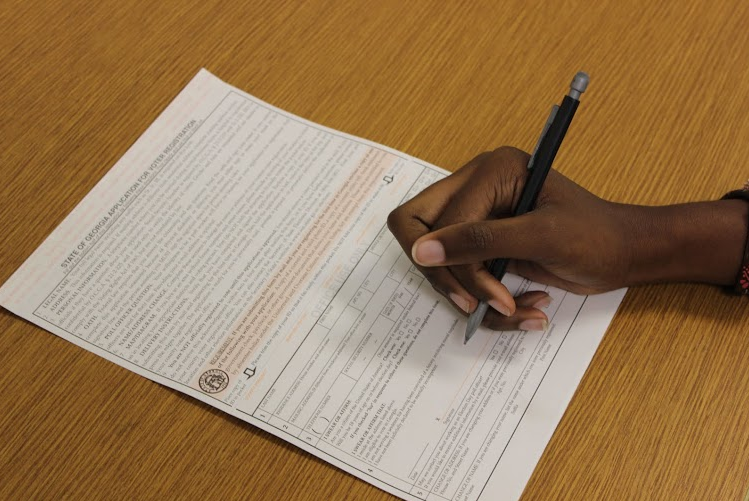A student fills out the Georgia Voter Registration form. These forms are available in the Guidance Office.