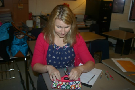 English teacher Jillian Bowen sorts through a small portion of her brightly colored pen collection to find the perfect color to grade papers. 