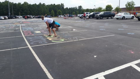 Seniors decorate the parking spaces in the student lot to celebrate the first day of their final year of high school. Many students of the Senior class get together the day before school and chalk their spaces to secure good spots and show their seniority to the underclassmen.