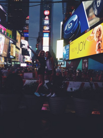 Kayla Mapel and McKaleigh Lonobile, a friend from the Joffery’s Jazz Intensive summer program, hop on top of large planters to see all the digital lights of Times Square after a day of dance at Pearl Studios. 