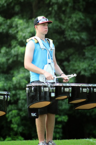 A percussionist of Panther Pride stands in attention while rehearsing field placement and music.