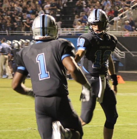 Sophomore quarterback Joey DeLuca congratulates fellow sophomore running back Rico Frye after a touchdown run in the third quarter. 