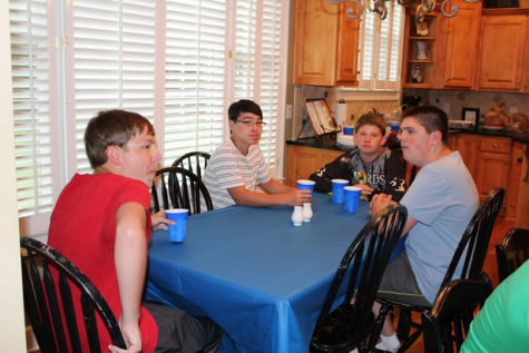 Members of the trumpet section meet for a section dinner. They bond with one another after a long day of marching band rehearsal at one of the member’s house. 