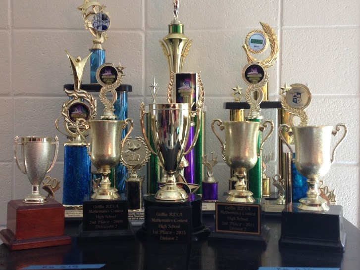 Math+Team+coach+Wendy+Willoughby+displays+numerous+trophies+from+the+team%E2%80%99s+previous+victories.+The+team+added+to+this+collection+last+year+with+a+first-place+victory+at+the+Griffin+RESA+tournament.+