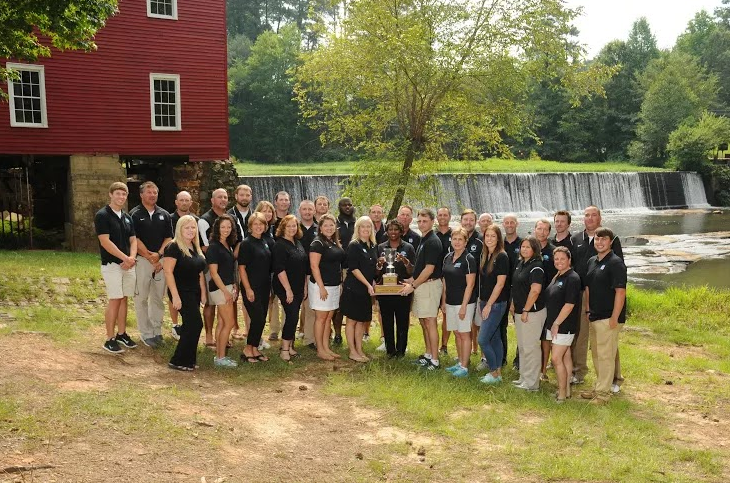 The Panther coaches pose in front of the Mill with former Principal Audrey Toney with the 2015 Director’s Cup. These coaches dedicated their teams’ years to doing the best they can and advancing into the playoffs and championships.