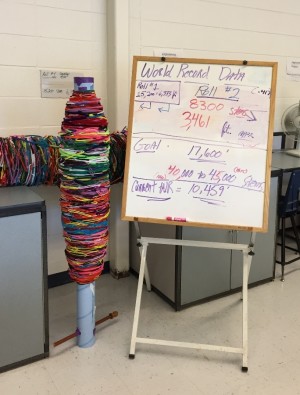 This board is displayed in Jonathan Winkjer’s room to show the statistics for the current length of the longest pipe cleaner chain in the world and how much work is left to meet the goal. Cylinders holding the beginning of their pipe cleaner chain stand next to it. 