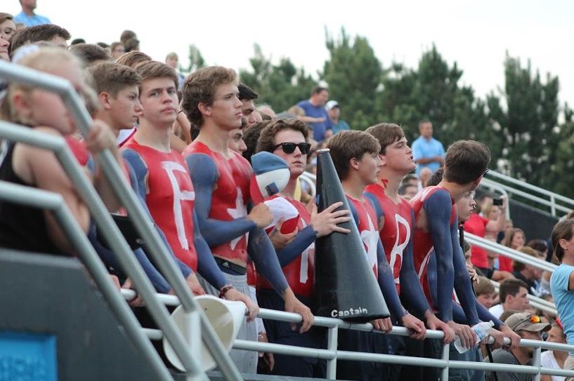 Seniors listen to the Wind Ensemble and chorus perform the “Star Spangled Banner” before the beginning of the football game against Dutchtown on Sept. 11. In honor of Patriot’s Day, they swapped Panther blue and black for red, white and blue. 
