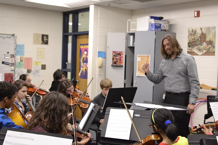 Oct. 16, 2015 - Nathan Kufchak conducts “The Twelve Days of Christmas” during the seventh period orchestra class. They will perform this song during their holiday performance on Dec. 3 in Duke Auditorium.
