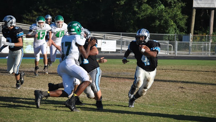 Sophomore running back Nick Brown races for the sidelines in attempt of reaching the first down.