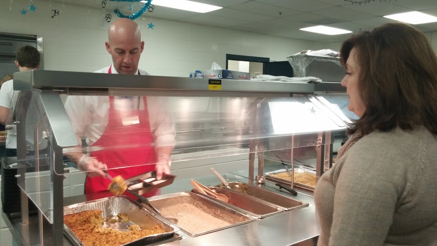 Nov. 12, 2015 - Principal Allen Leonard serves the Thanksgiving meal in the cafeteria during B lunch to English teachers. “Hashtag no hair net needed,” Leonard said. 