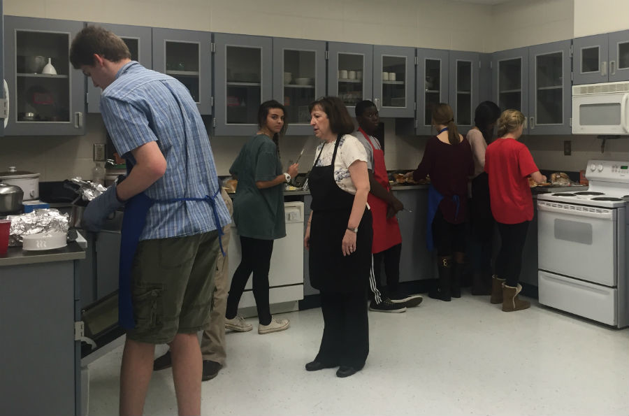 Students finish up the last touches on the food while the first few people arrive the Mama Mia dinner. Family, Career and Community leaders of America sponsor Cheryl Clower uses this dinner as a fundraiser for the club.