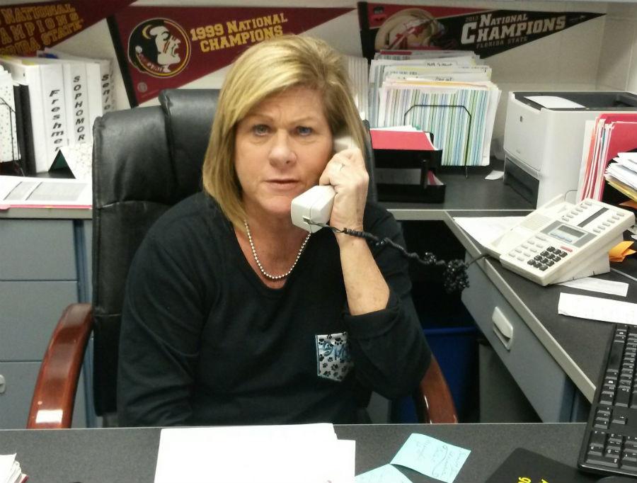 Guidance counselor Colleen Petty speaks on the phone with a parent during 7th period.