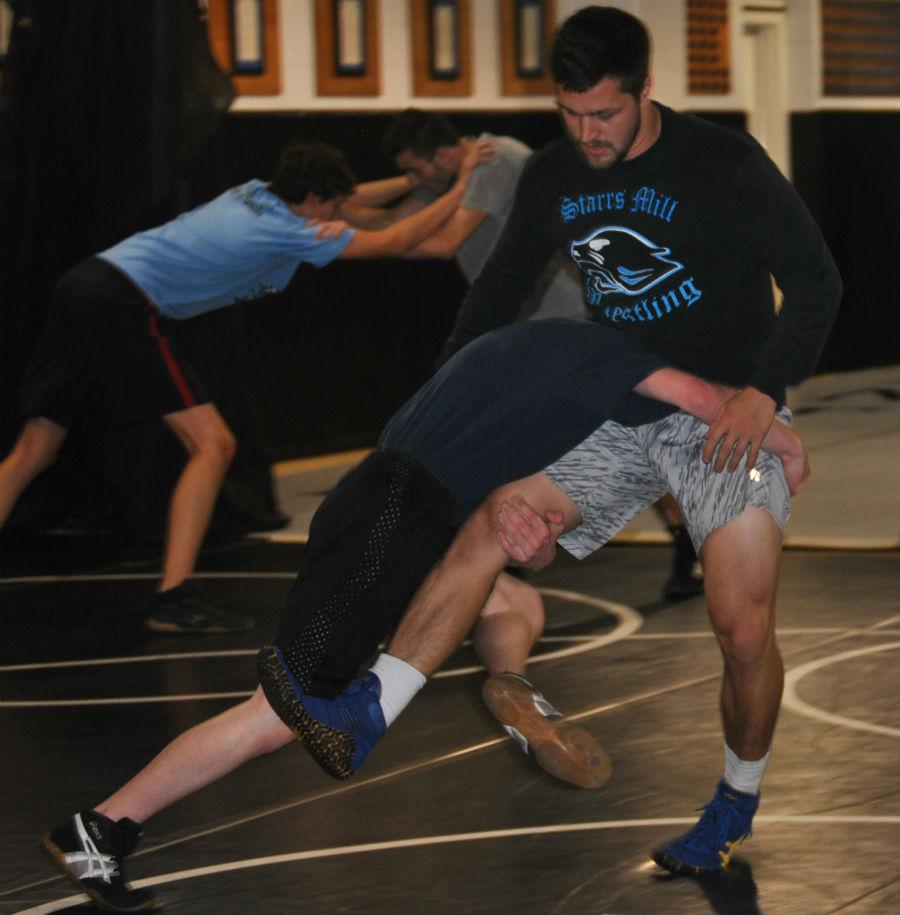 Senior and four-year wrestler practices with assistant coach Jason Allen during an after school practice.