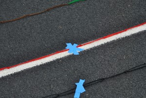 Oct. 24, 2015 - Masking tape is used to hold the pipe cleaners in place as they loop around the track.