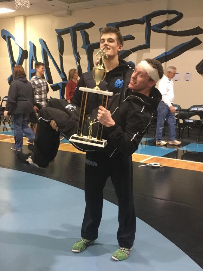 Wrestlers pose proudly with their first-place trophy after area duals on Jan. 9. 