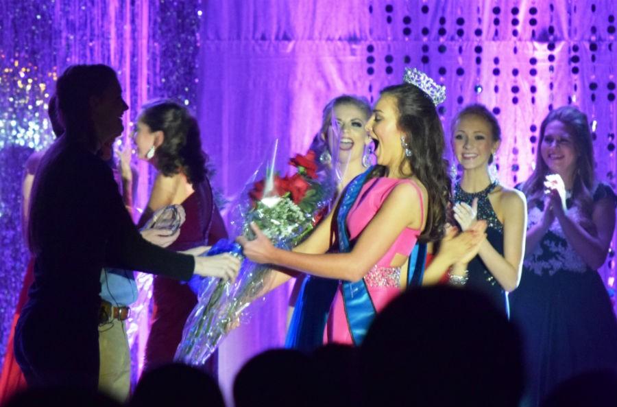 The 2016 Miss Starr’s Mill winner receives her flowers from the stage manager after 2015 Miss Starr’s Mill Yuri-Grace Ohashi crowns her.