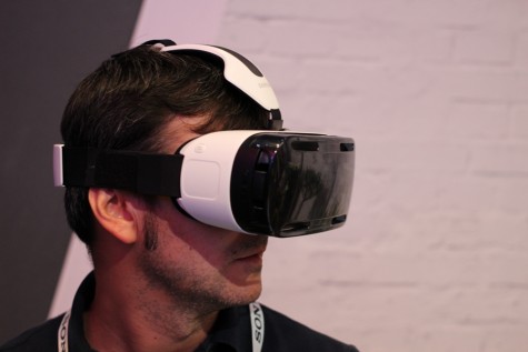 A man samples the Samsung Gear virtual reality headset at the DC Startup Showcase demonstrating the Biz Potential of Virtual Reality. This kind of virtual reality headset has become a favorite for consumers, and this technology is taking hold of the business world.