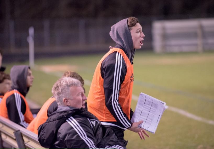Senior soccer captain helps coach Mike Hanie on the sidelines after being benched for the season because of a torn ACL. Injuries to key players have a large effect on the results of a season, and returning that player to the field can be concerning for both the player and the coach.