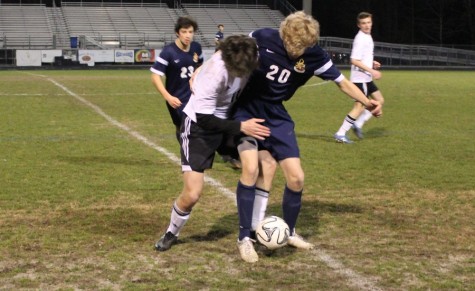 March 2, 2016- A St. Pius and Panther player fight for the ball. The Panthers struggled offensively against a Golden Lions team that has only allowed three goals in its six victories this season, but bounced back with a 6-0 win at home against Ola High School on March 8.
