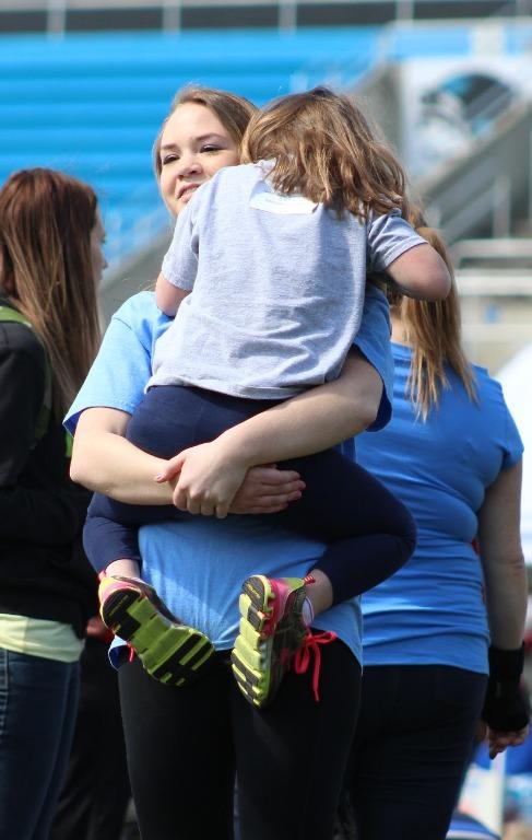 A PALS coach hugs her athlete during the track and field Special Olympics. Students had the opportunity to volunteer as coaches of the special olympians and provide them with constant encouragement.