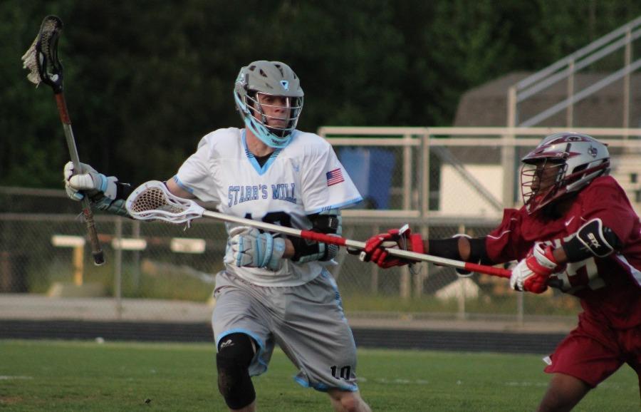 A Panther player evades a Grady defender on his way toward the goal. The Panthers’ strong third quarter secured their 14th straight victory.