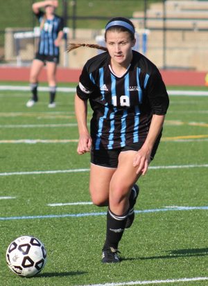 A Lady Panther soccer player dribbles the ball up field during a semifinal match against Columbus. 