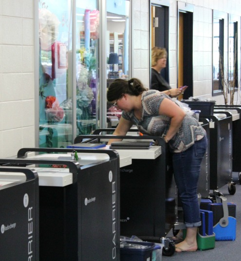 April 27, 2016- The administrators and the teachers who do not teach a class during seventh period help media specialist LeighAnne Hanie gather and check all the Chromebook carts before Georgia Milestone testing. This statewide standardized test will be completed by students on the Chromebooks for certain classes such as Biology, Economics or American Literature.