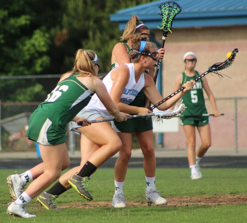 A Panther player runs through two defenders on her way toward the goal. The Panthers defense rarely communicated and couldn’t stop the Titans offense. “They were nimble and used a lot of backdoor cuts,” Goins said. “Our communication definitely needed some improvement.”