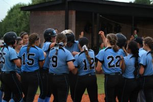 Aug. 16, 2016 - Panther varsity softball team gathers at home plate to celebrate an RBI against McIntosh. The Panthers went on to win the game for their second win of the season.