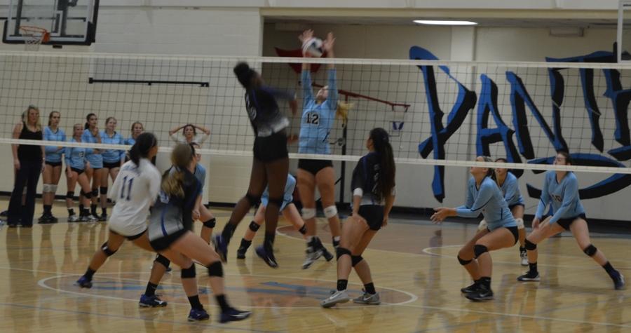 Junior Lauren Avidano blocks a spike attempt by the Johns Creeks attack. “[Avidano] really stepped up and hustled to make important plays to keep us in the game,” Ellison said. 