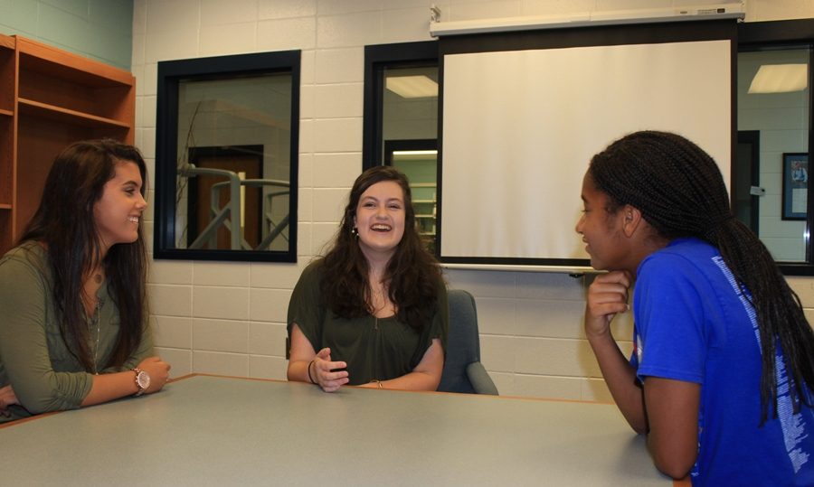 Junior Madison Martin explains her ideas for the new writing group to two students. The group will hold its first meeting at 7:00 p.m. on Sep. 15 at the Peachtree City Library in the readers and writers room. 
