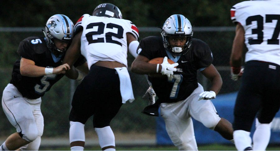 Junior running back Nick Brown avoids two Patriot defenders. The Panther backfield gained 161 yards against a tough Sandy Creek defense.