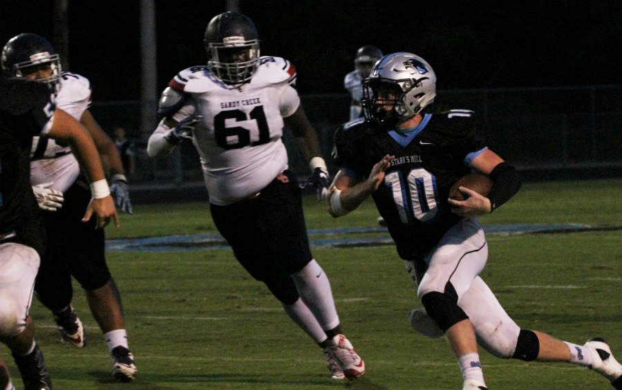 Junior Ryan Cockes runs an interception back during the third quarter of Friday’s game. The Panther defense forced two turnovers to keep them in competition with the Patriots.
