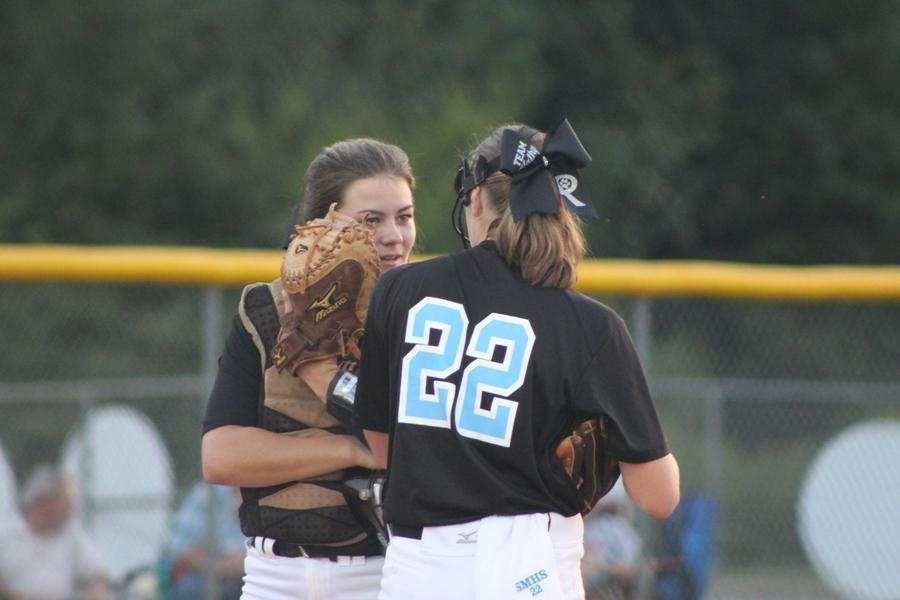 Sophomore catcher Makaela Sigler chats with freshman starting pitcher Paige Andrews. Andrews pitched four and one-third innings, giving up seven hits and four runs.