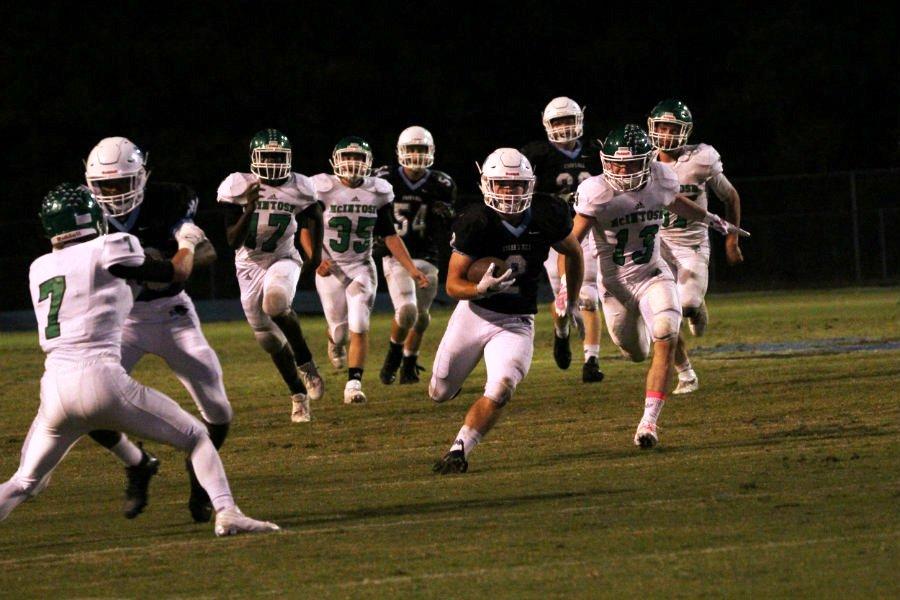 Junior running back Cole Gilley races past the McIntosh defense during Friday night’s 28-7 victory. Gilley ran for 137 yards against the Chiefs, becoming the first running back in the region to pass 1,000 rushing yards this season.