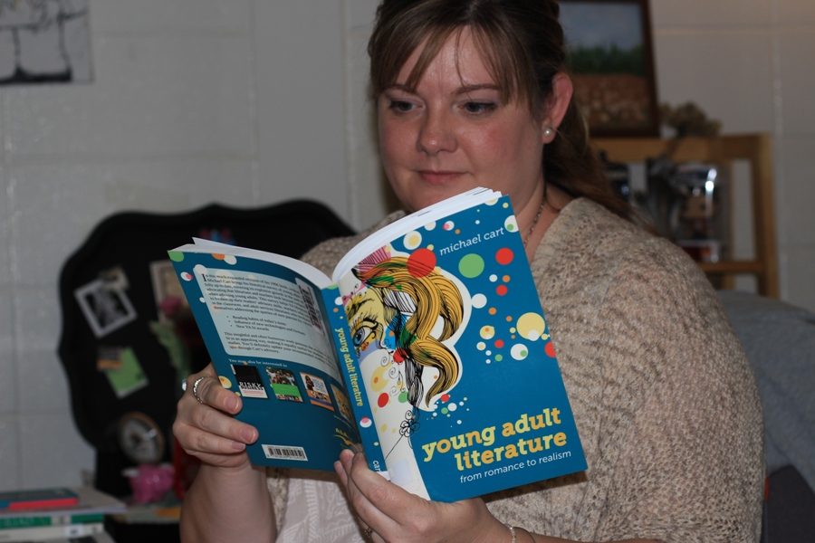 Dr. Leila Crowder opens her copy of “Young Adult Literature.” “It’s a book I used for part of my research, I learned about the history of young adult literature,” Crowder said. Crowder spent three years at Mercer University to become a doctor in Curriculum and Instruction and awaits the graduation ceremony in May of 2017.