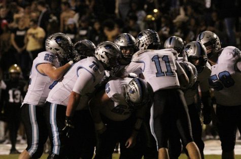 Panther offense huddles before a play against Fayette County. “I think this game was probably the best game [the offensive line] has had all year,” junior quarterback Joey DeLuca said. 