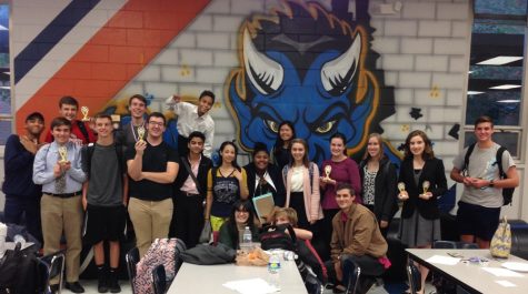 Debate coach and English teacher Brandon Kendall (lower right) poses alongside debate team competitors after the tournament at Columbus High School on Oct. 22. “There are a total of 45 members of debate team, but we usually take 30 to 35 students [to each tournament],” Kendall said.