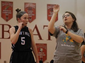 Assistant coach Emily Woodward coaches a Lady Panther in shooting. The Panthers won their first scrimmage against Our Lady of Mercy, 40-27, on Wednesday night.